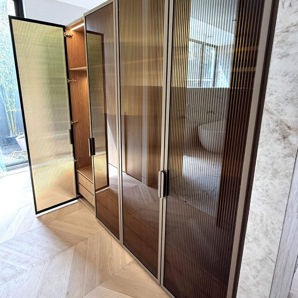 Glass doors with bronze reeded film installed