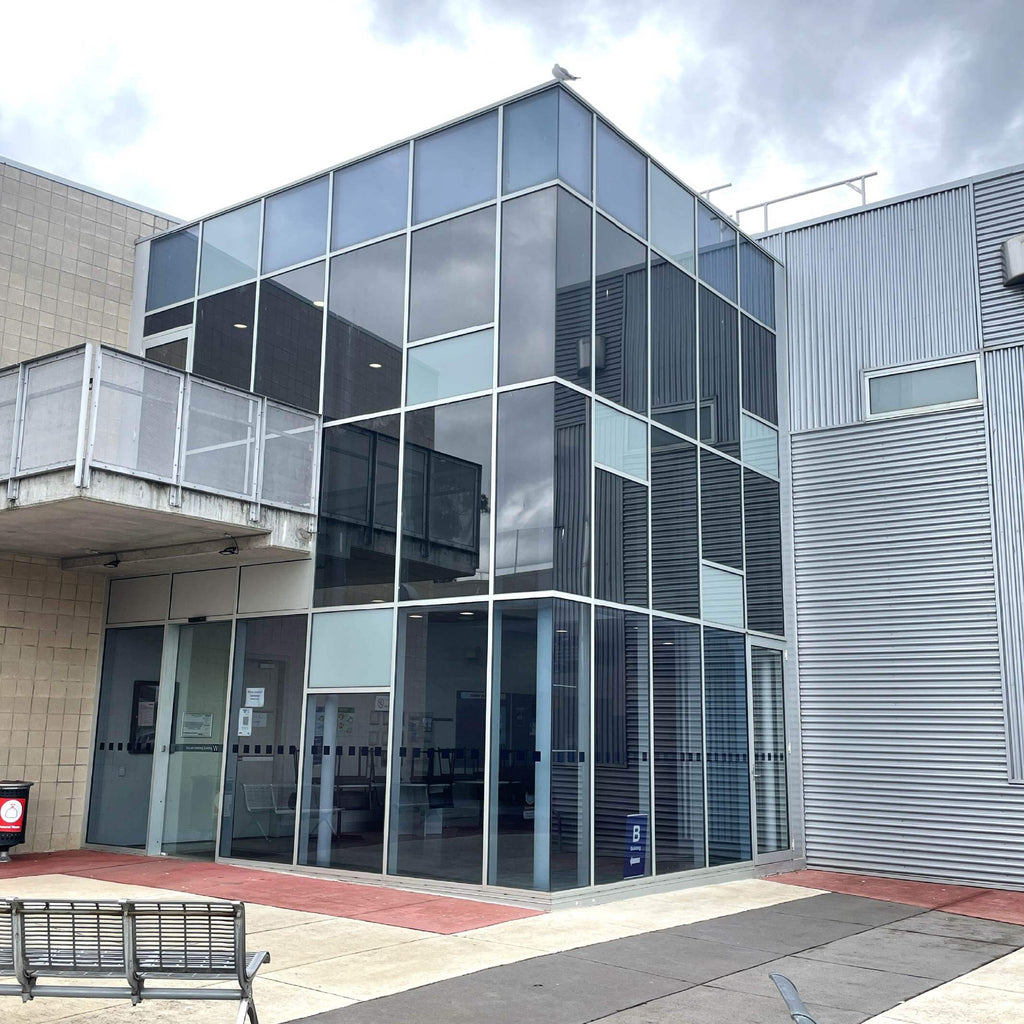 Modern education building with glass facade and metal exterior